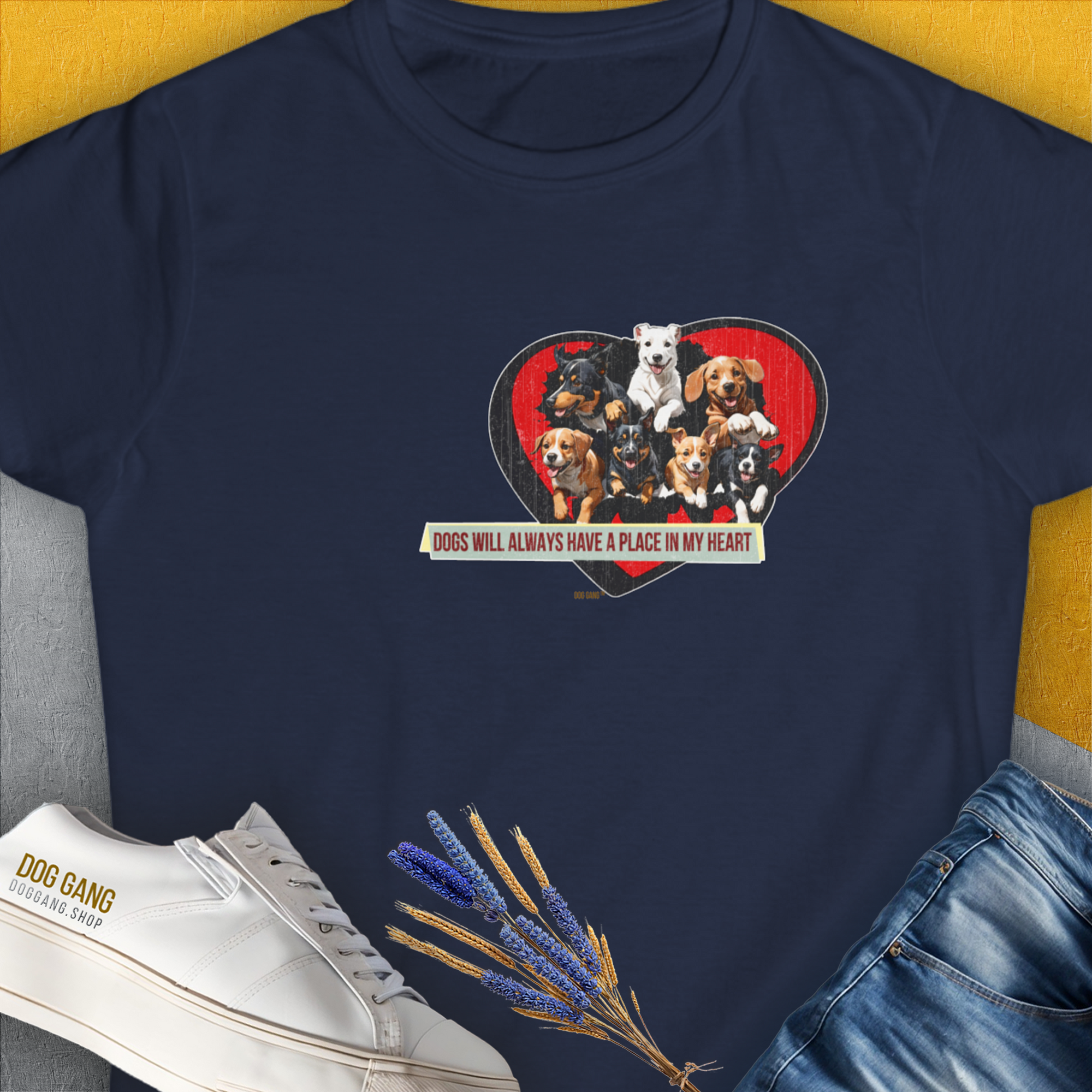 The navy t-shirt showcases a cute dog design with a heart filled with adorable dog illustrations, accompanied by the quote Dogs Will Always Have A Place In My Heart. Designed by Dog Gang.