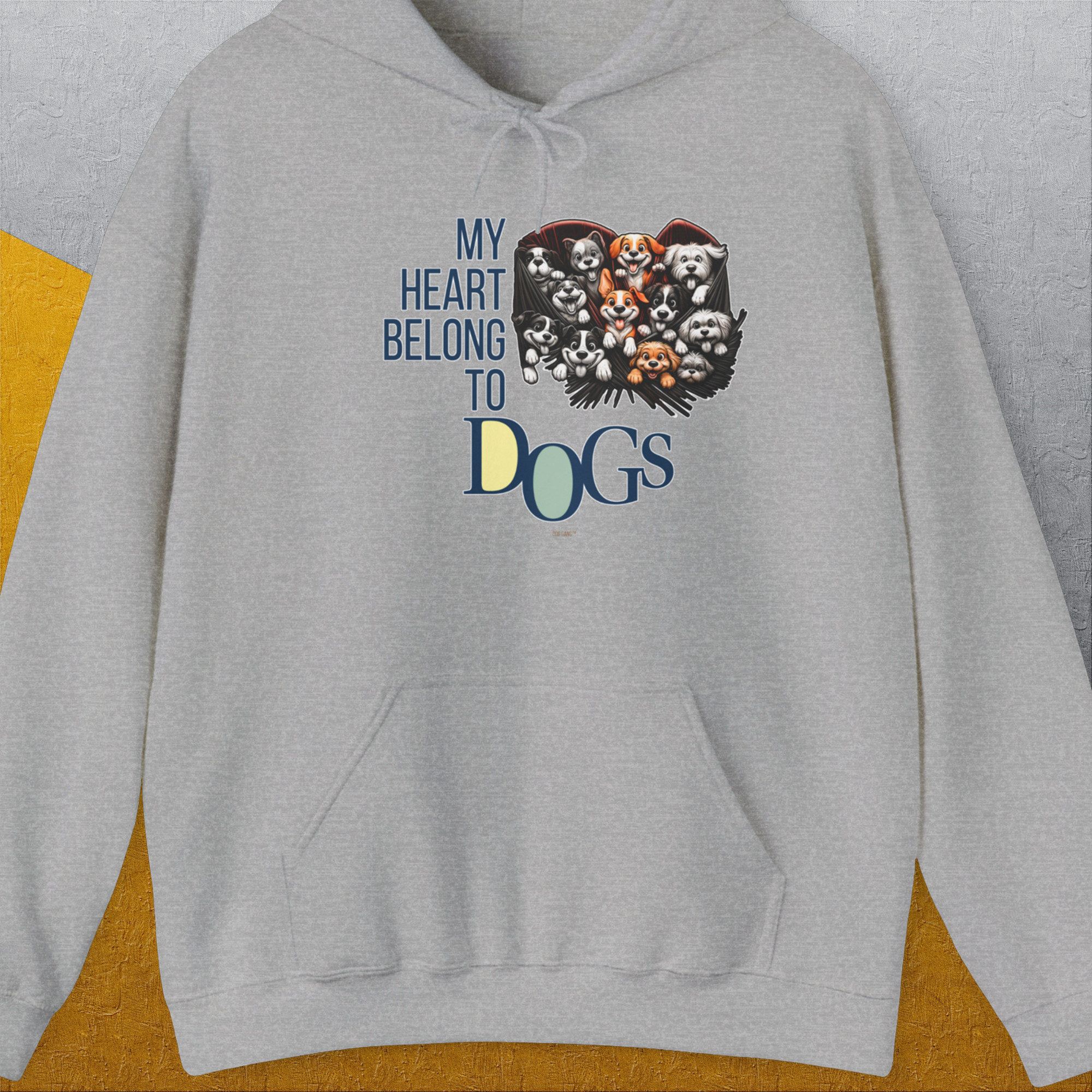 This funny dog shirt displays a heart-shaped collage of adorable dog faces with the quote My Heart Belongs to Dogs. Designed by Dog Gang.