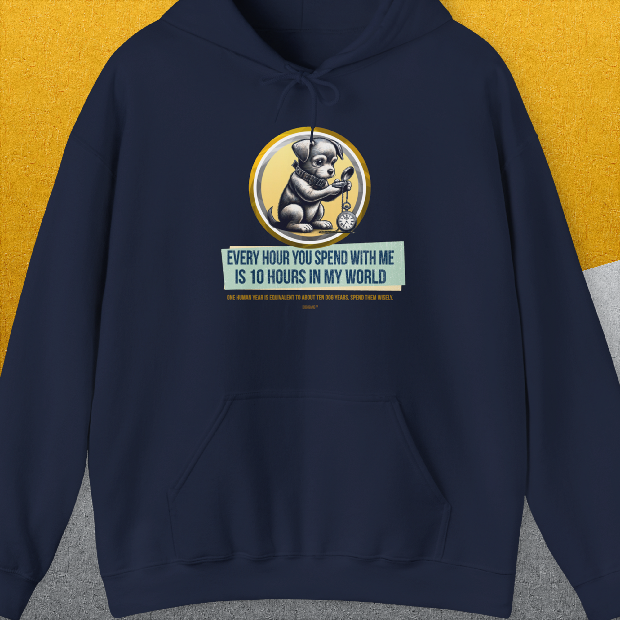 Navy hoodie with a dog-themed illustration and the quote “Every hour you spend with me is 10 hours in my world.” Designed by Dog Gang.
