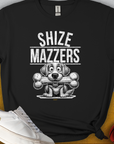 The Shize Mazzers Volume 4 Unisex T-shirt features a funny dog design with SHIZE MAZZERS and a cartoon dog holding a bone in its mouth. Perfect for any dog lover. Designed by Dog Gang.