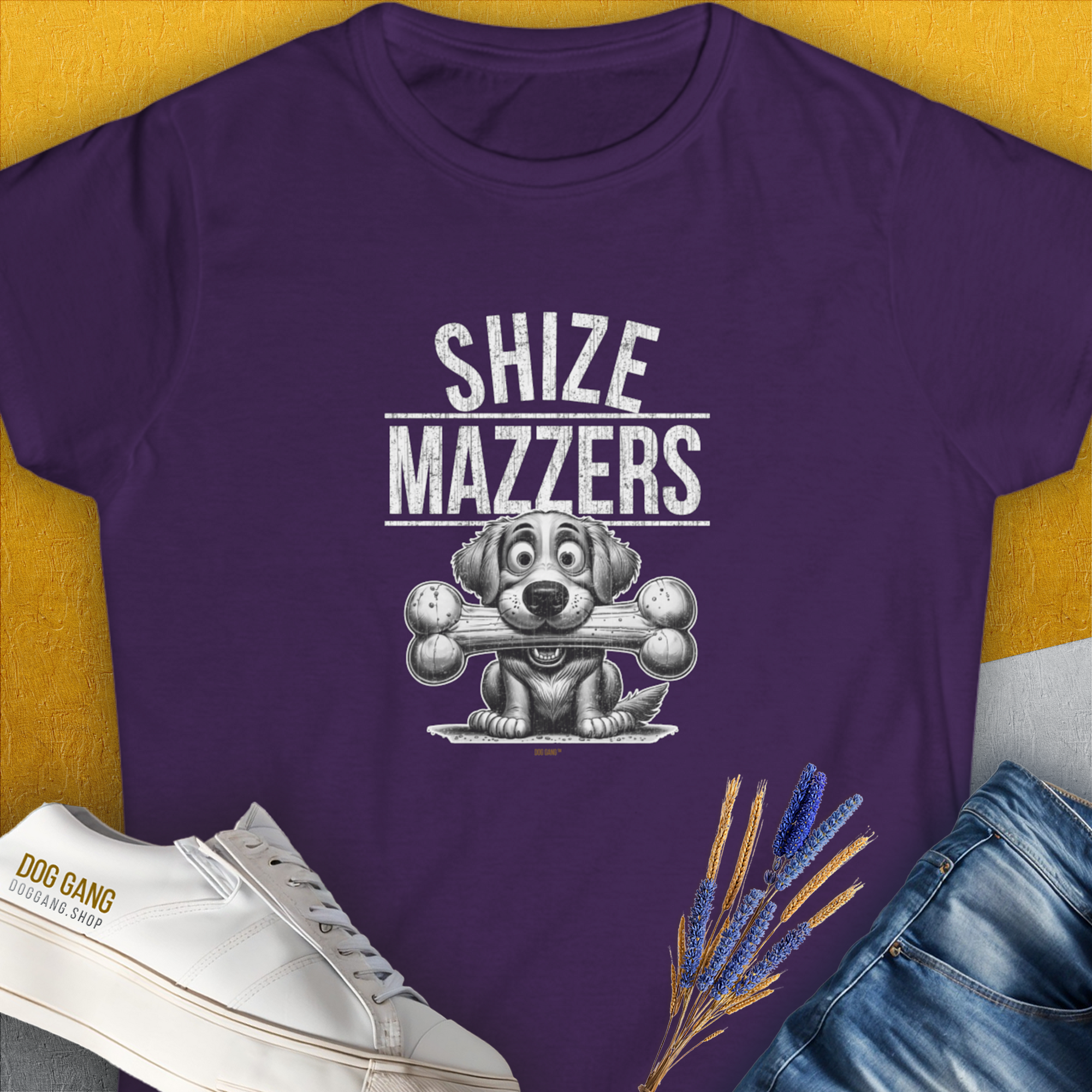 a funny shirt featuring a cartoon dog holding an oversized bone in its mouth, preventing it from speaking properly. The text reads "SHIZE MAZZERS". Perfect for any dog ​​lover. Designed by Dog Gang.