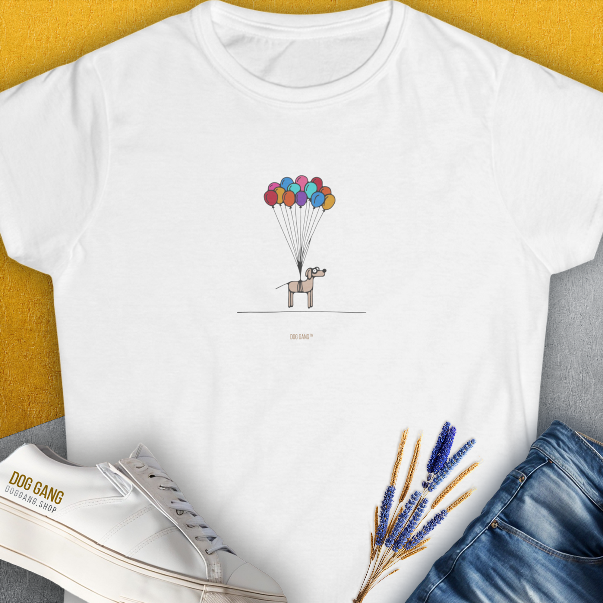 Cute dog design featuring a cartoon pup lifted by colorful balloons adds a whimsical touch thats perfect for any dog lover. Designed by Dog Gang.