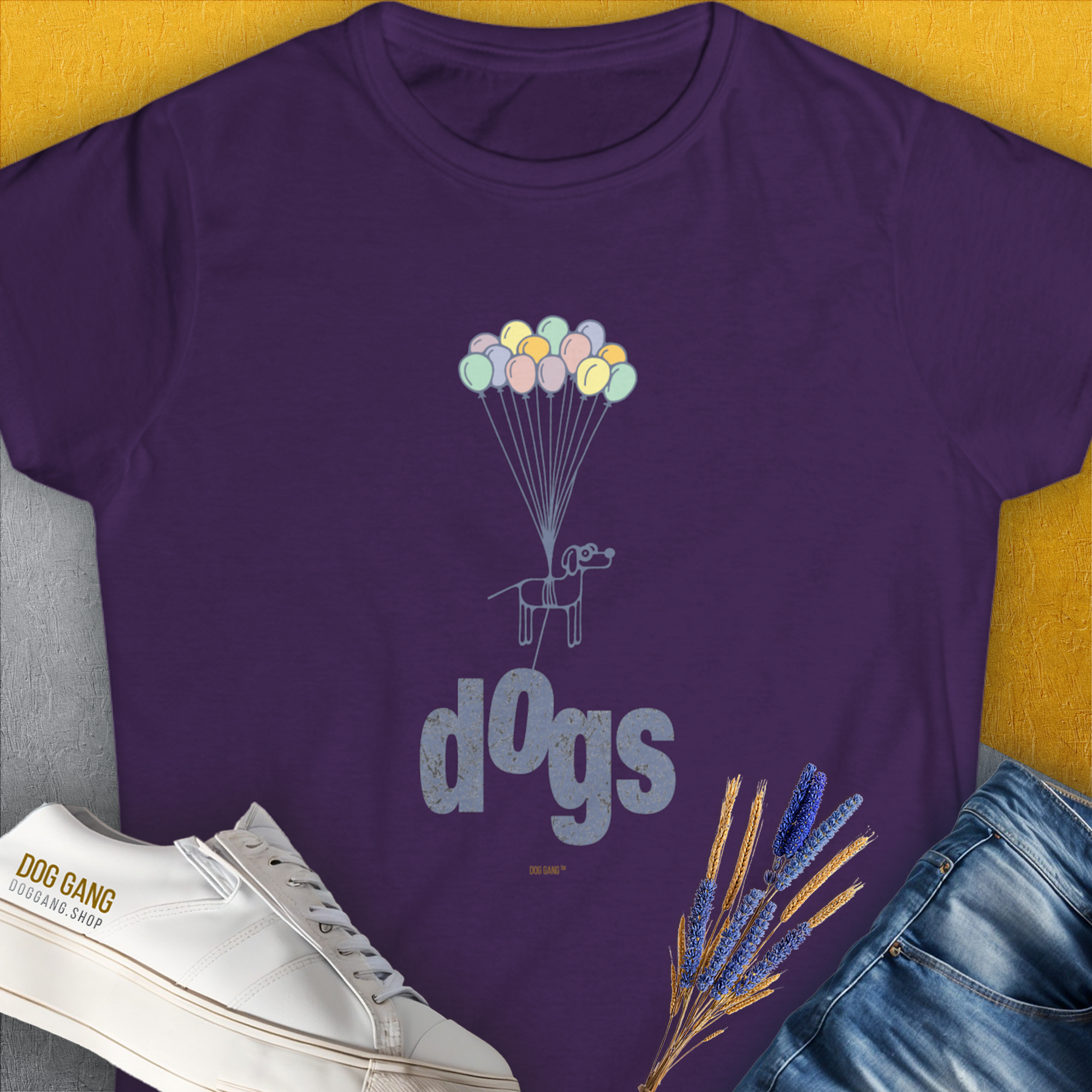 Featuring a cute dog with balloons and the word dogs, this funny dog shirt is perfect for any dog person. Designed by Dog Gang.