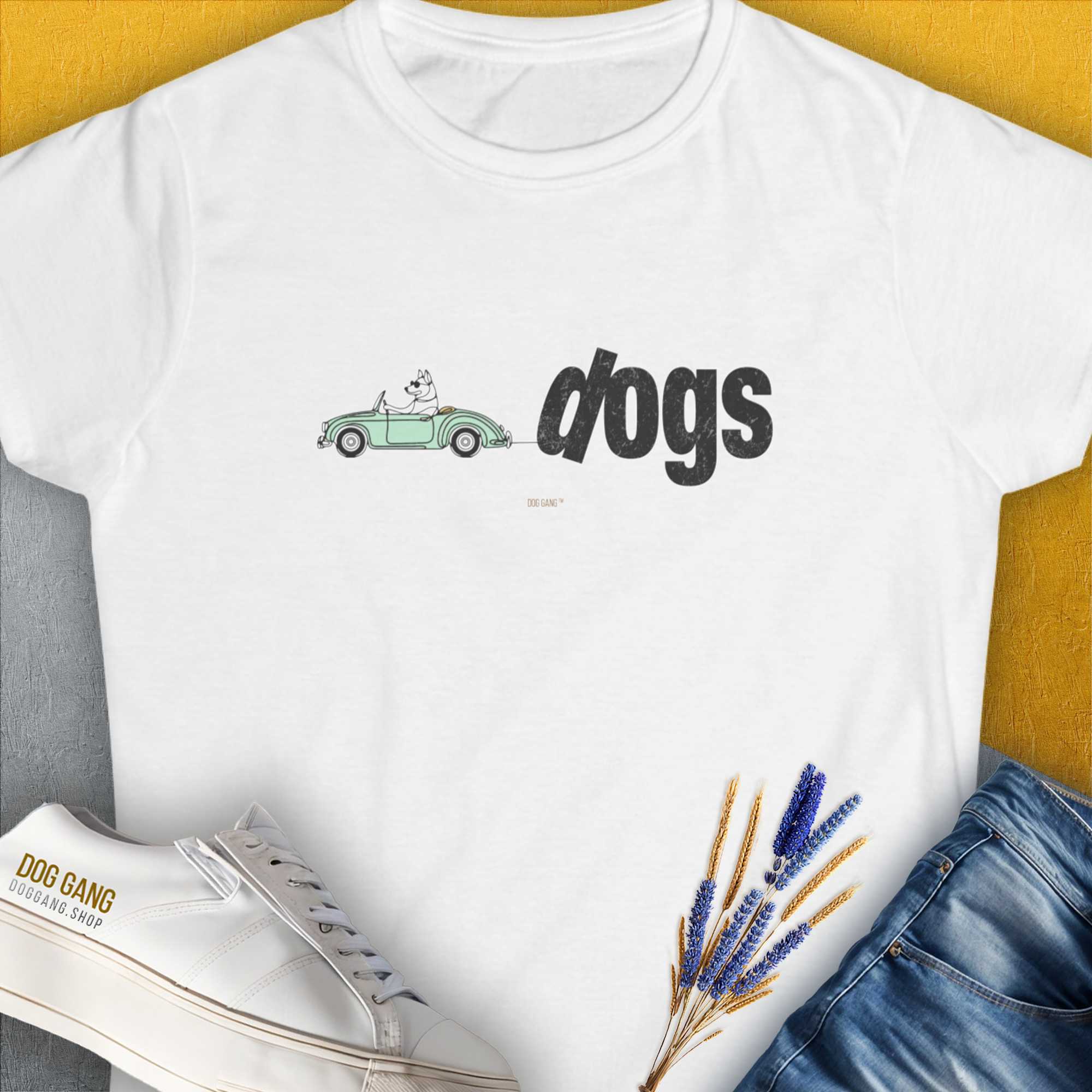 The Dog Gang Minimalistic Series II, Volume 2 Womens T-shirt features a playful dog illustration in a green car with dogs beside it. A perfect dog-themed piece for any dog lover. Designed by Dog Gang.