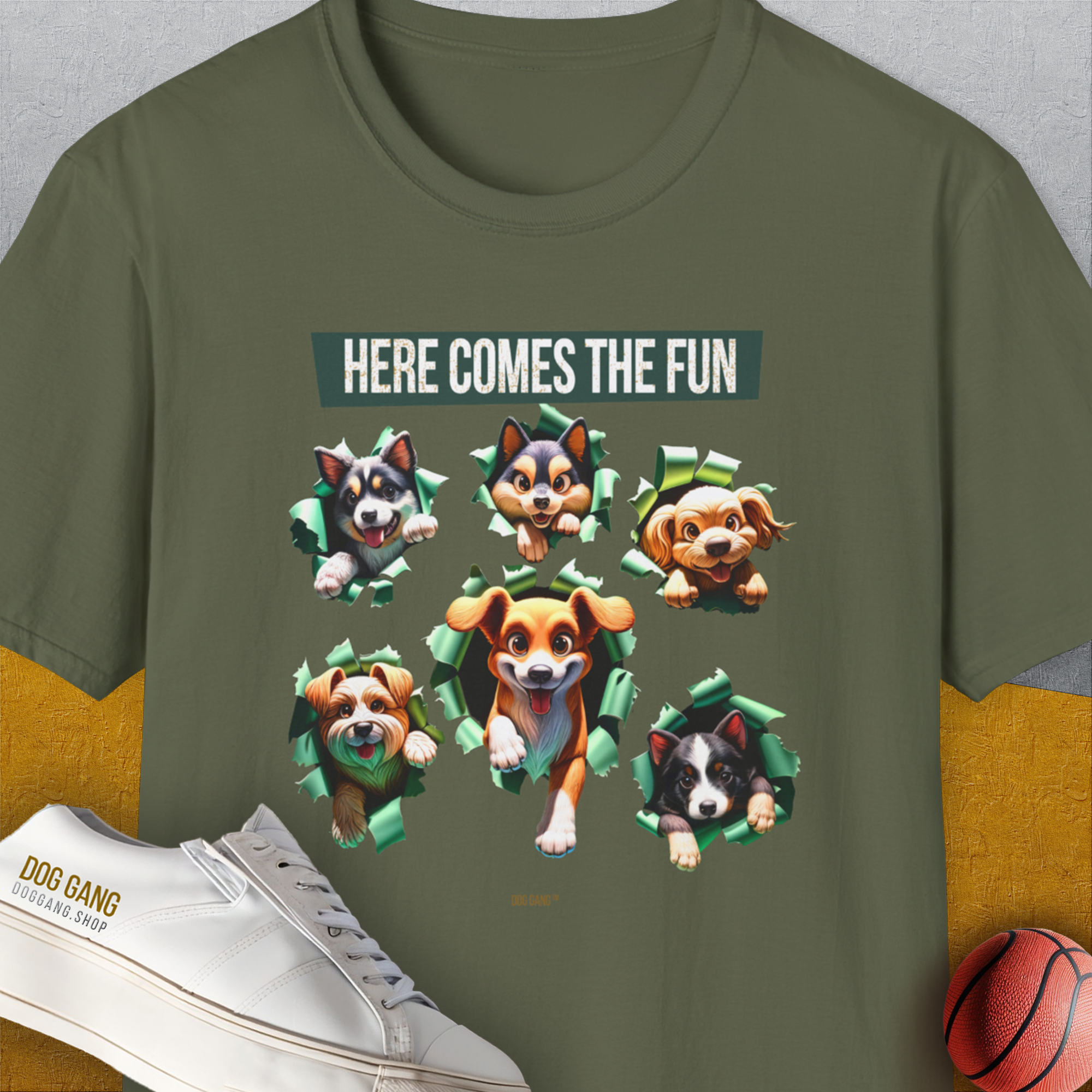 The Unleash-Series Volume 4 T-shirt, military green, 100% cotton, showcases six cartoon dogs with the saying Here Comes the Fun. A must-have for any dog person. Designed by Dog Gang.