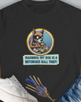 The Warning: My Dog Is A Notorious Ball Thief womens T-shirt features a cheeky dog illustration and playful text, perfect for any dog person. Designed by Dog Gang.