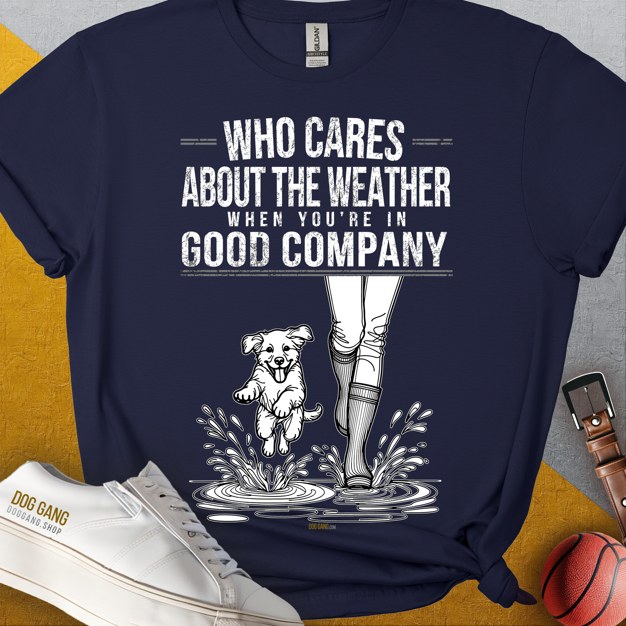 Das Unisex-T-Shirt „Who Cares About The Weather When You're In Good Company?", Volume 2“ zeigt eine verspielte Grafik einer Person und eines Hundes im Regen. Aus 100 % Baumwolle. Design von Dog Gang.
